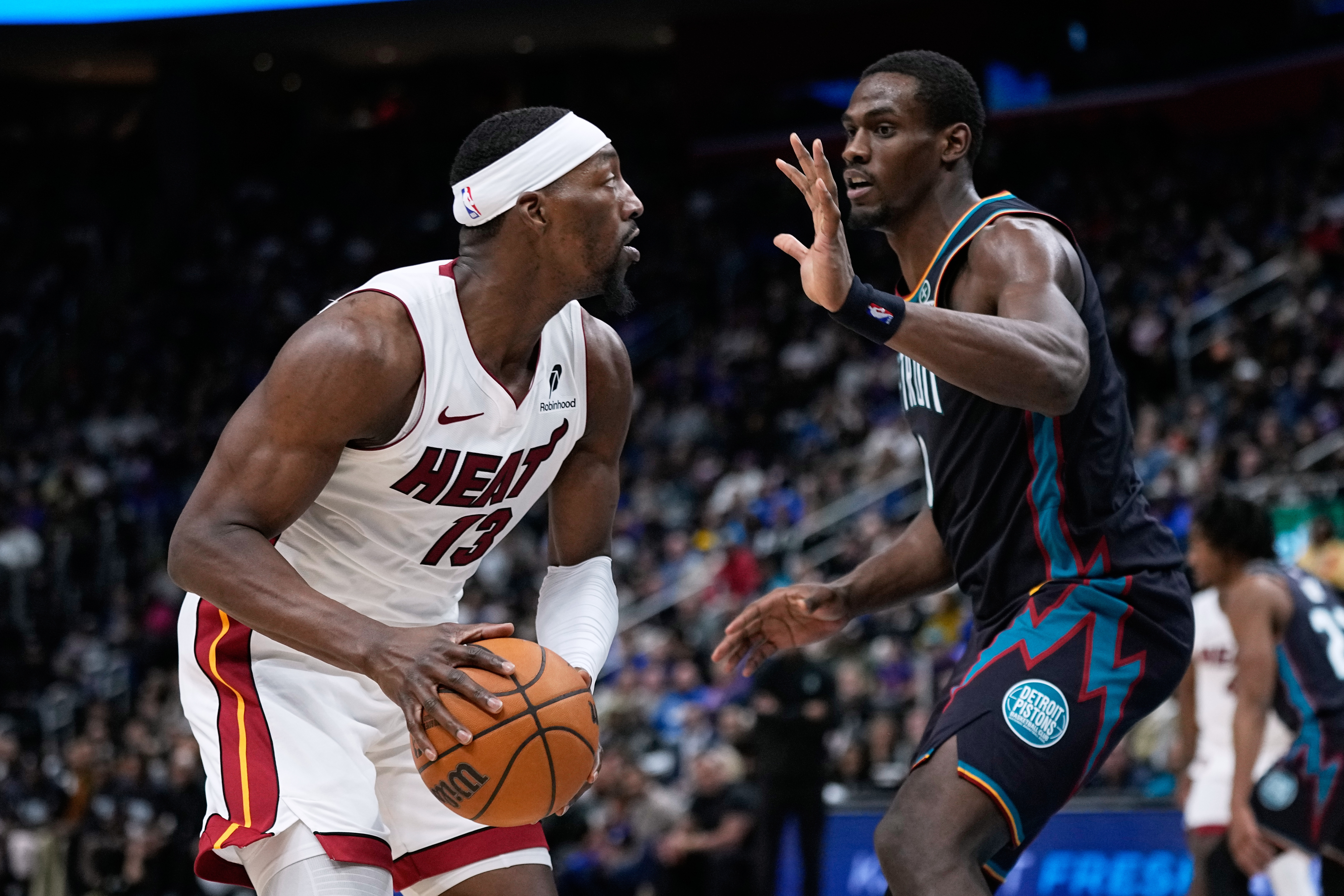 Miami Heat center Bam Adebayo, left, is guarded by Detroit Pistons center Jalen Duren during the first half of an NBA basketball game, Thursday, Jan. 1, 2026, in Detroit. (AP Photo/Ryan Sun)