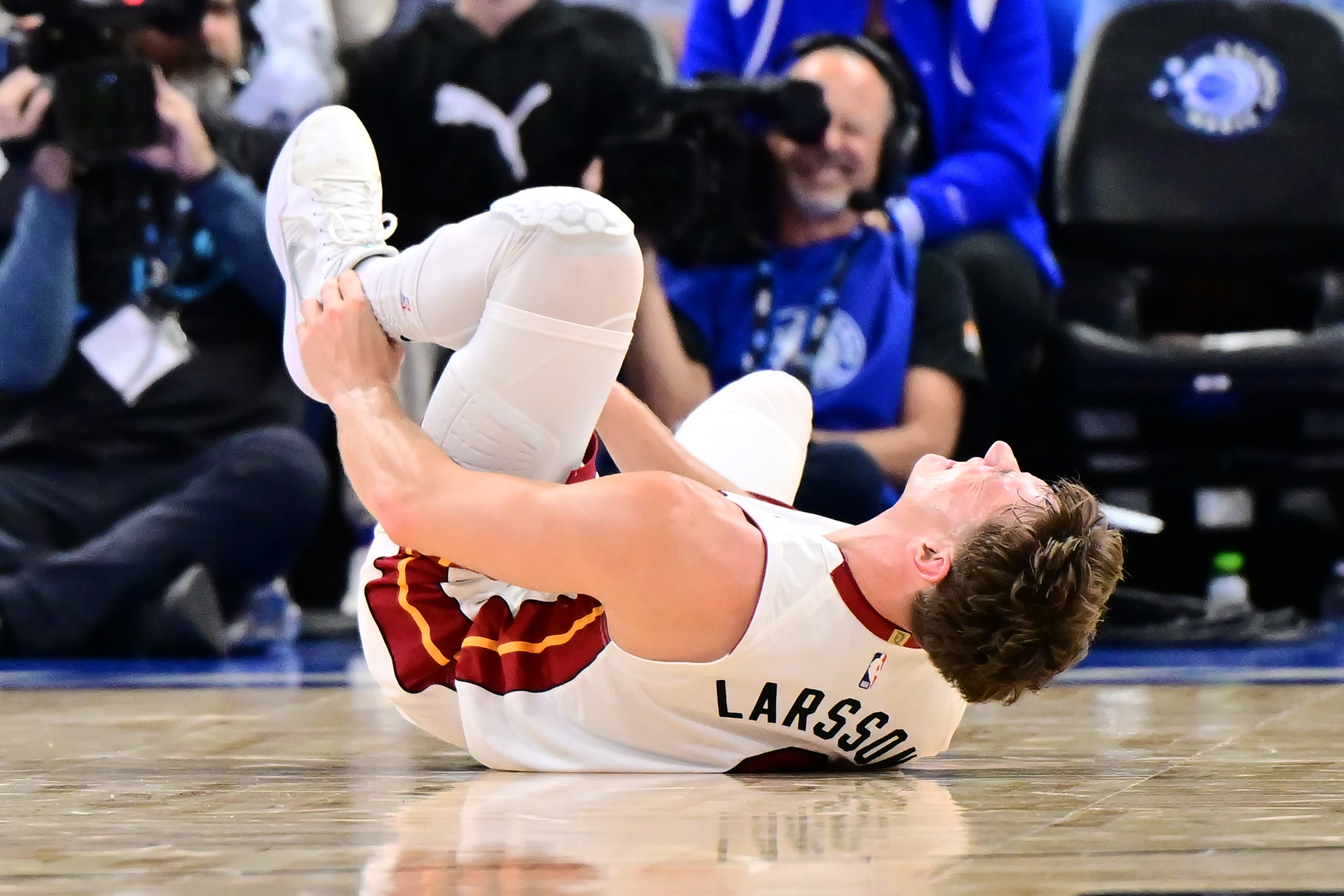 heat guard Pelle Larsson holds his ankle after an injury in the first half of a Emirates NBA Cup Quarterfinals game against the Orlando Magic at Kia Center on December 09, 2025 in Orlando, Florida. (Julio Aguilar/Getty Images)