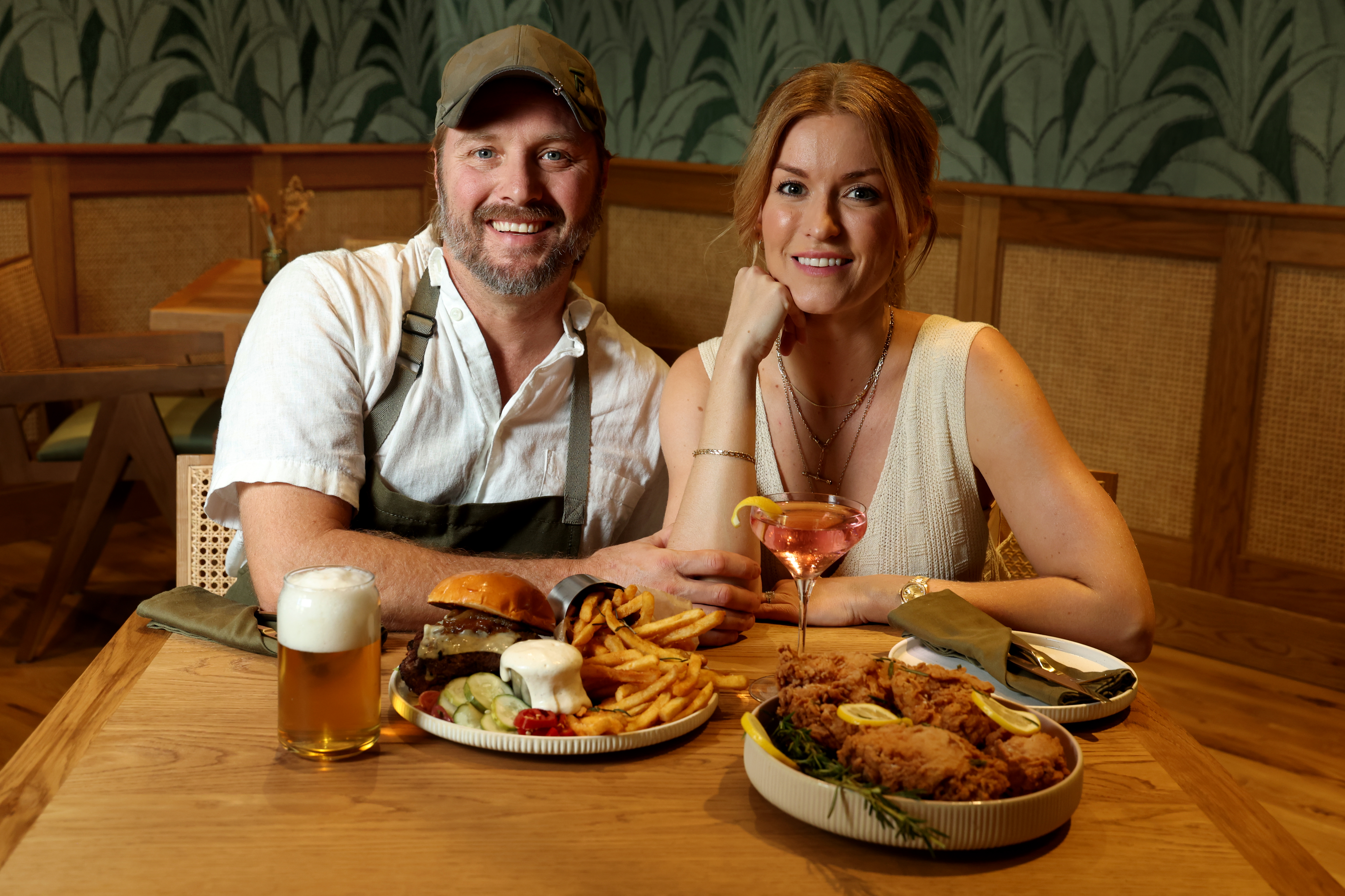 James Beard Award-nominated chefs Jeff McInnis and Janine Booth at the Florida Room at The Fort pickleball complex in Fort Lauderdale, with the burger and chicken sandwich inspired by their trips to Shake Shack. (Mike Stocker/South Florida Sun Sentinel)