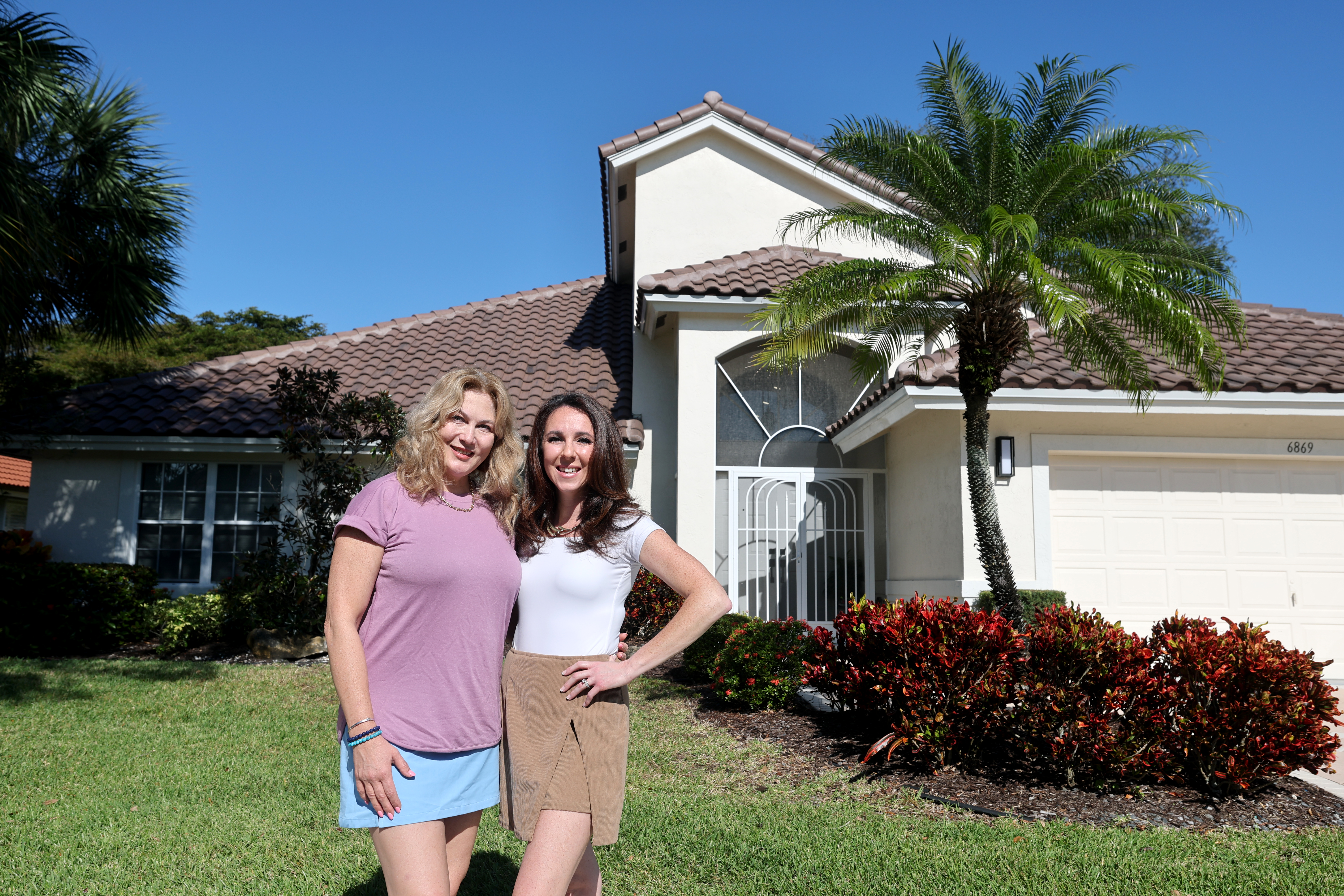 Randi Petlakh, right, and her cousin Katya Bratslavsky stand in front of the home Bratslavsky and her husband recently purchased, Friday, Dec. 26, 2025. The house was originally bought by Petlakh’s grandparents in 1996. After being sold and renovated by a contractor, Bratslavsky bought the property in May, unaware of the family connection. (Mike Stocker/South Florida Sun Sentinel)