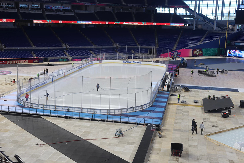 Workers spray water down on the ice rink at LoanDepot Park. The rink will host South Florida's first ever outdoor hockey game— the 2026 Winter Classic. (Carlton Gillespie / WLRN Public Media)