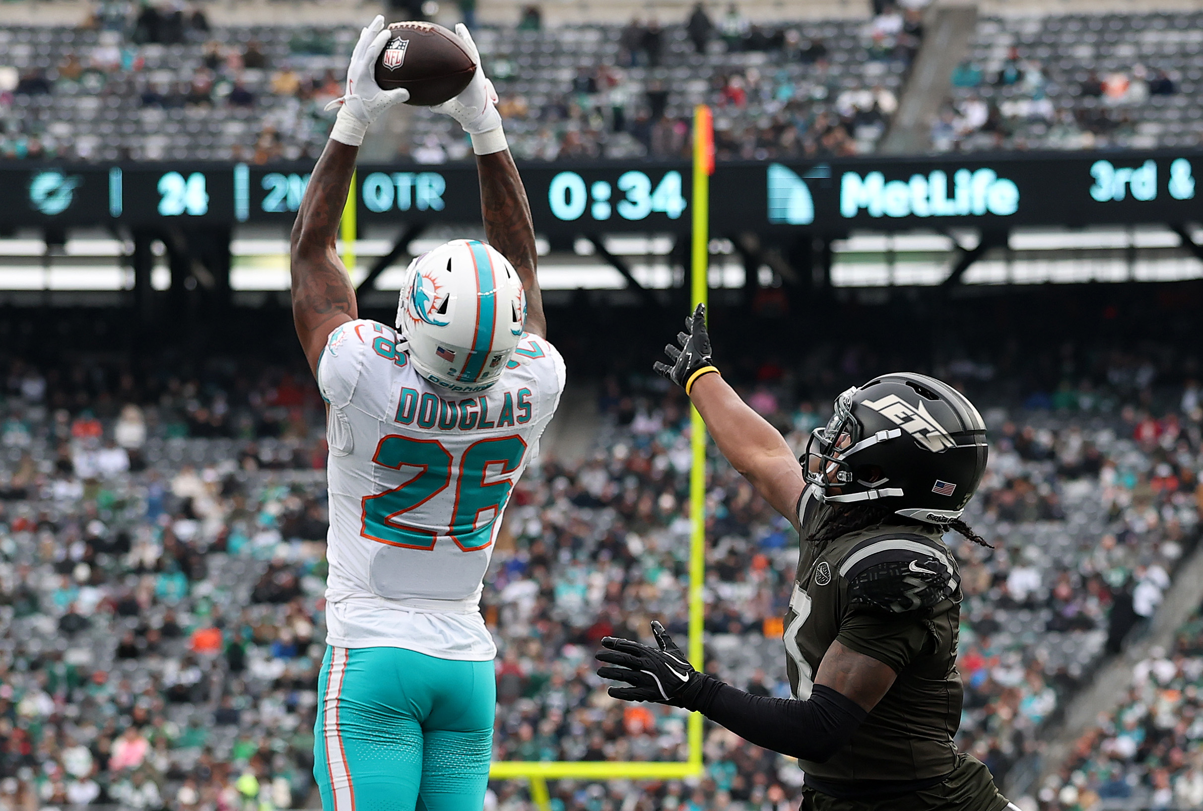 Rasul Douglas (26) of the Miami Dolphins intercepts a pass intended for John Metchie III (3) of the New York Jets during the second quarter at MetLife Stadium on Dec. 7, 2025, in East Rutherford, New Jersey. (Kenneth Richmond/Getty Images/TNS)